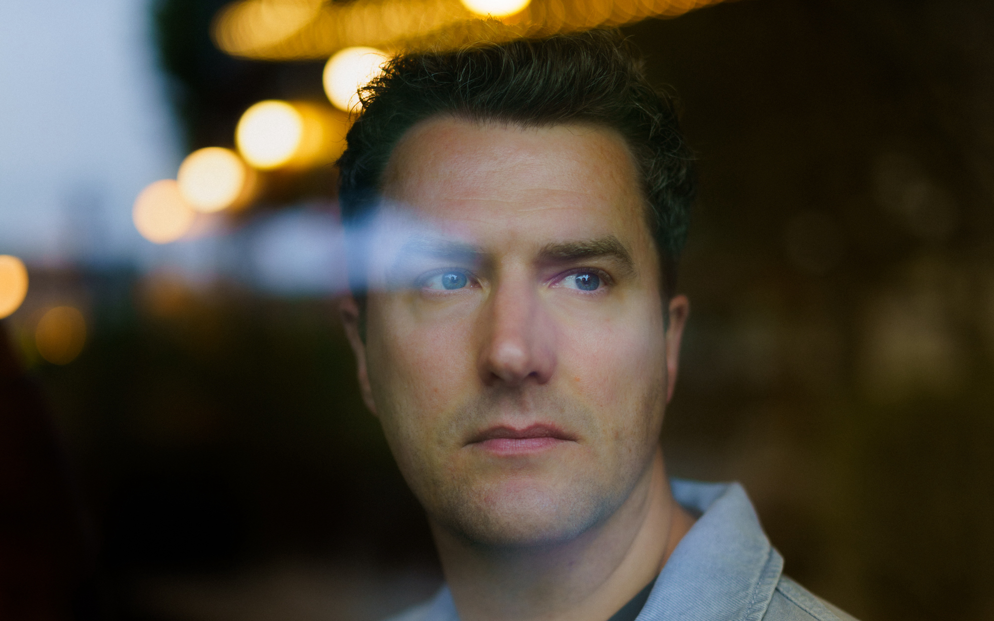 Portrait of Mark Bowden under some lights